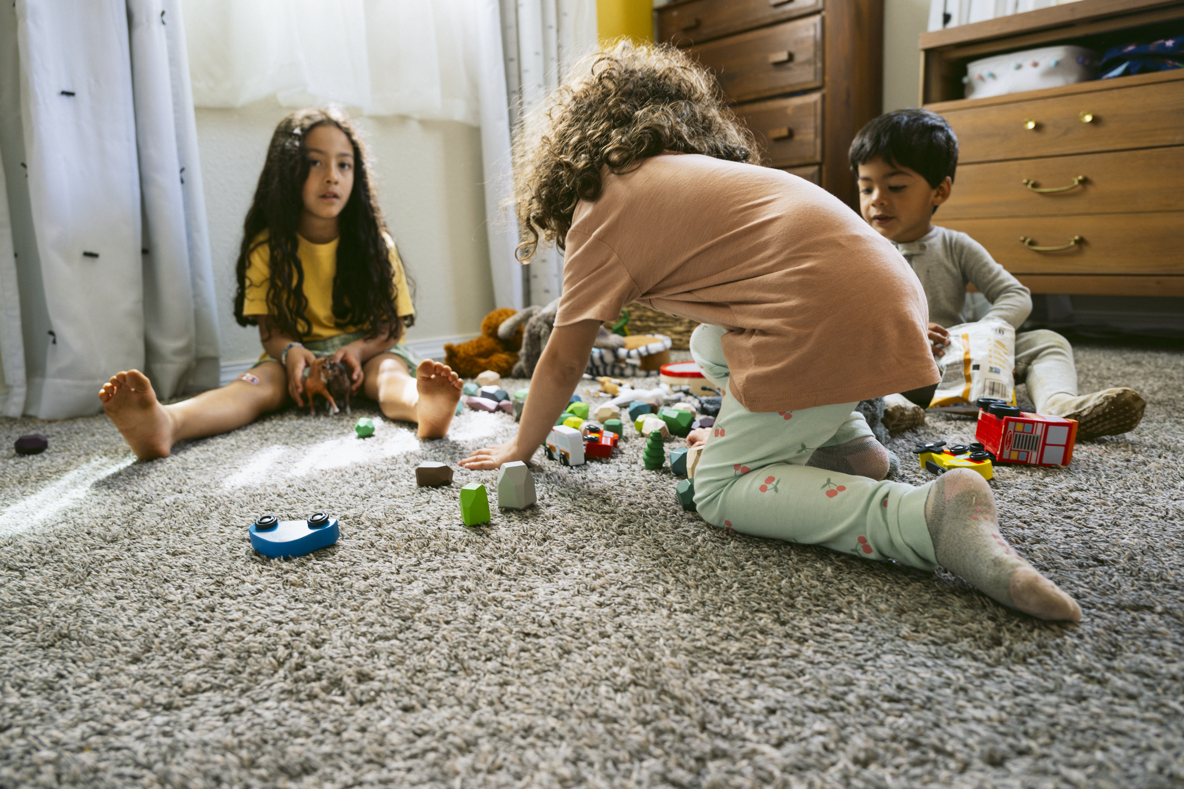 Children playing with toys in bedroom.